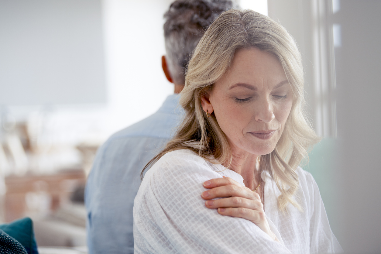 Mature Couple Fighting At Home Sitting On The Sofa.